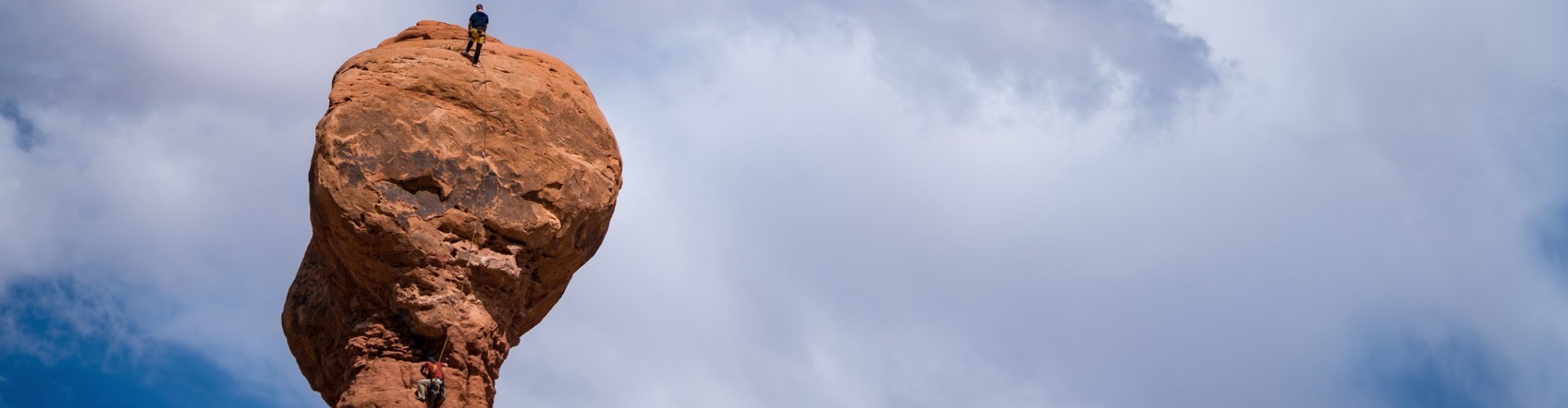 men climbing rock in utah